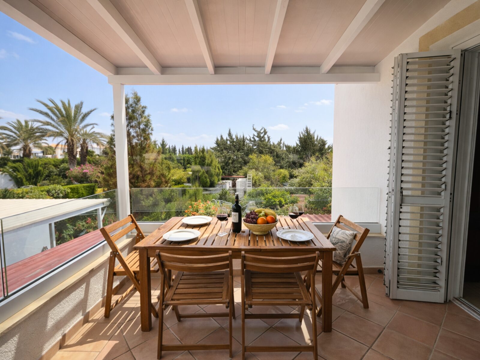 Pervolia veranda after renovation, pergola and dining table over the gardens